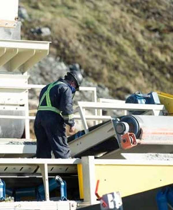Man Inspecting Conveyor Belts